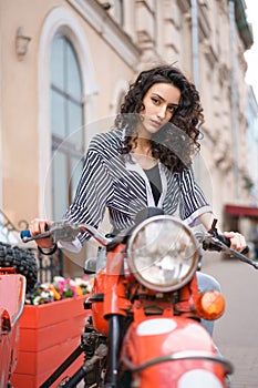 Young beautiful woman on motorcycle driving