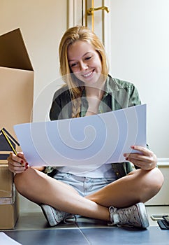 Young beautiful woman moving in new home.