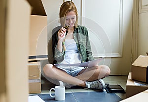 Young beautiful woman moving in new home.