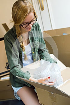 Young beautiful woman moving in a new home.