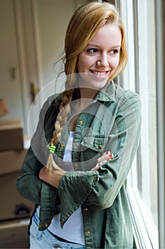 Young beautiful woman moving in a new home.