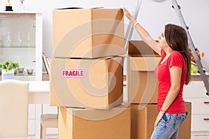 The young beautiful woman moving to new flat