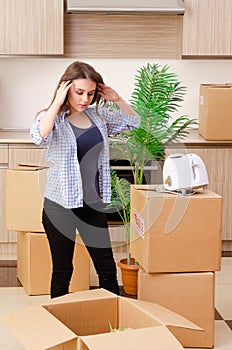 The young beautiful woman moving to new flat