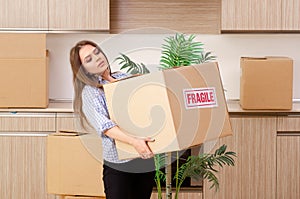 The young beautiful woman moving to new flat