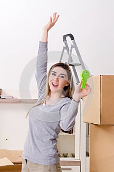 Young beautiful woman moving to new flat