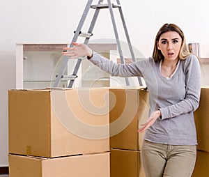 Young beautiful woman moving to new flat