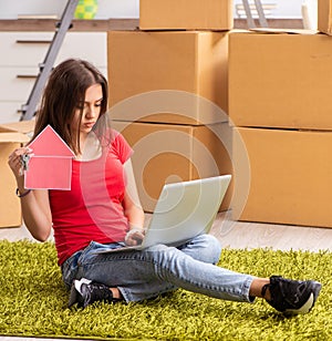 Young beautiful woman moving to new flat