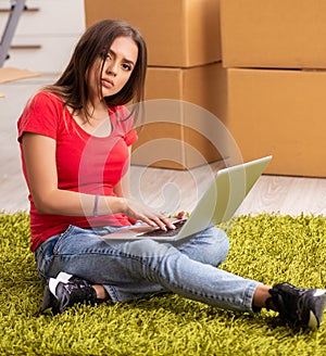 Young beautiful woman moving to new flat