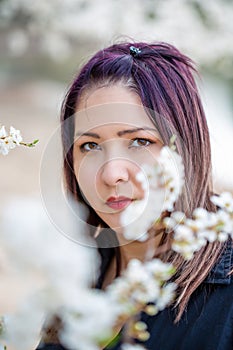 Young beautiful woman near blossoming tree 2