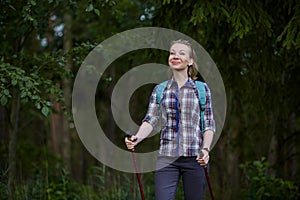 Young woman with nordic walk pols photo