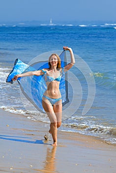 The young beautiful woman on an ocean coast. Indon