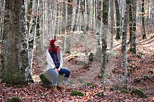 Young beautiful woman in one of the most amazing beech forest in Europe, La Fageda d'en Jorda, an amazing forest.