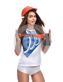 Young beautiful woman in orange construction safety hat show axe