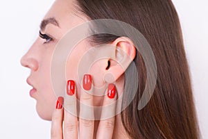 Young beautiful woman with perfect skin touching her ear. Cosmet photo