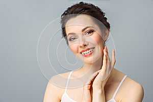 Young beautiful woman with perfect skin, touching her face. Cosmetology, beauty and spa concept.