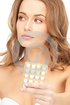 Young beautiful woman with pills