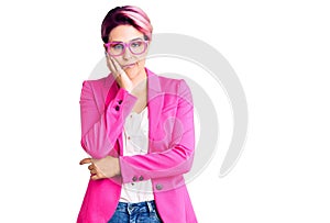 Young beautiful woman with pink hair wearing business jacket and glasses thinking looking tired and bored with depression problems