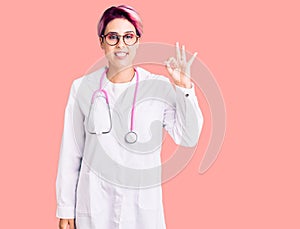Young beautiful woman with pink hair wearing doctor uniform smiling positive doing ok sign with hand and fingers