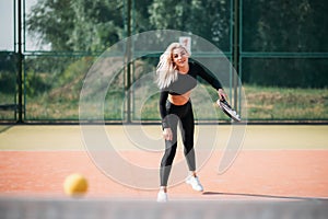 Young beautiful woman playing tennis on a court. Healthy sport lifestyle