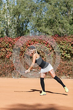 Young beautiful woman is playing tennis. In full growth.