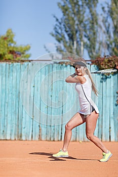 Young beautiful woman is playing tennis. In full growth.