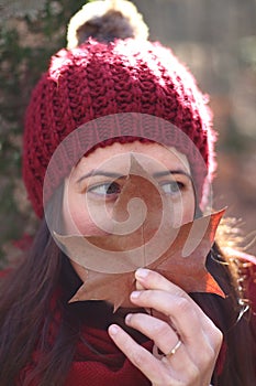 Young beautiful woman plays with beech leaves in one of the most amazing beech forest in Europe, La Fageda d'en Jorda.