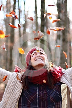 Young beautiful woman plays with beech leaves in one of the most amazing beech forest in Europe, La Fageda d'en Jorda.