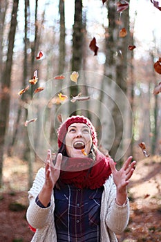 Young beautiful woman plays with beech leaves in one of the most amazing beech forest in Europe, La Fageda d'en Jorda.