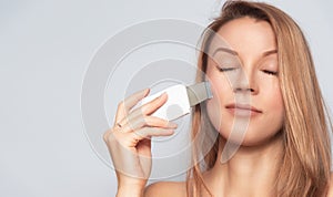 Woman with skin care treatment device. photo