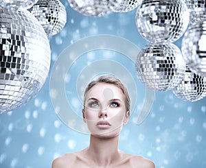 Young beautiful woman portrait with abstract mirror disco balls
