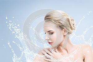 Young beautiful woman portrait with water splash