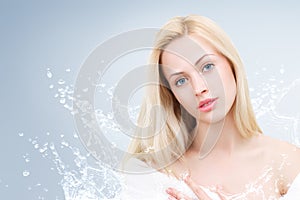 Young beautiful woman portrait with water splash