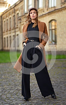 Young beautiful woman posing on city street