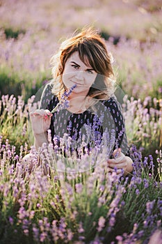 Young beautiful woman posing in a lavender field