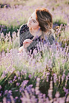 Young beautiful woman posing in a lavender field