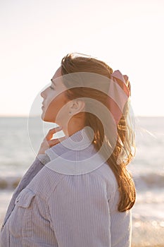 Young beautiful woman posing on summer beach