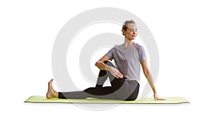 Young beautiful woman practicing yoga lesson on green yoga mat isolated on white background. healthy lifestyle concept