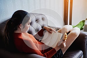 Young beautiful woman read a book with breakfast for relaxing holiday