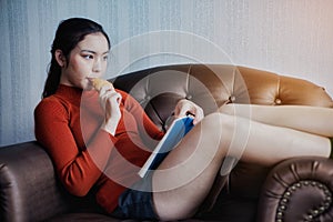 Young beautiful woman read a book with breakfast for relaxing holiday