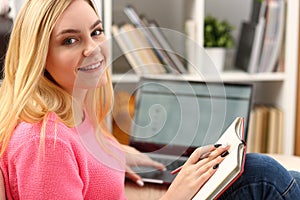 Young beautiful woman read book study hard prepare for exam