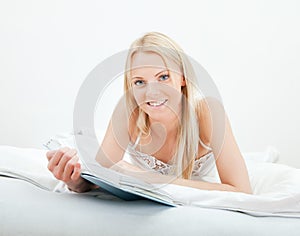 Young beautiful woman reading book