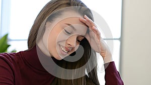 Young, beautiful woman reading menu in cafe