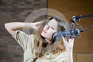 Young beautiful woman recording the sound