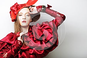 Young beautiful woman in a red lace suit and hat.