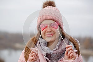 Young beautiful woman with red sweets on a stick in hands