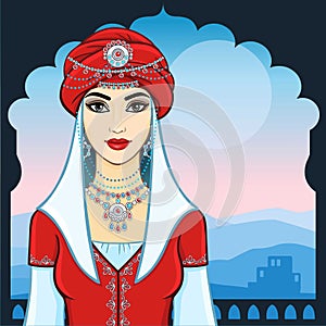 The young beautiful woman in a red turban and silver jewelry.