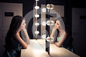 Young beautiful woman and reflection in dressing room