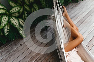 Young beautiful woman relaxing in hammock