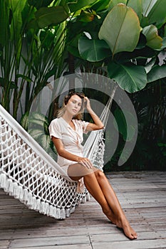 Young beautiful woman relaxing in hammock