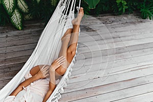 Young beautiful woman relaxing in hammock